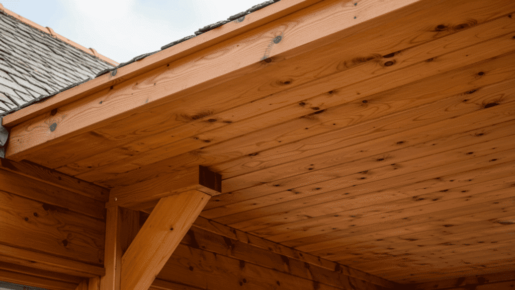 wooden soffit with natural grain under a roof overhang, warm tone finish adding a classic and traditional look to the structure.