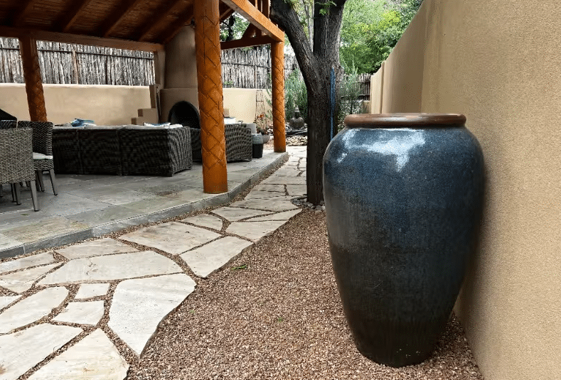 Tall planter on patio corner.