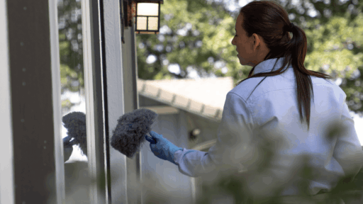 Woman checking the window sill.
