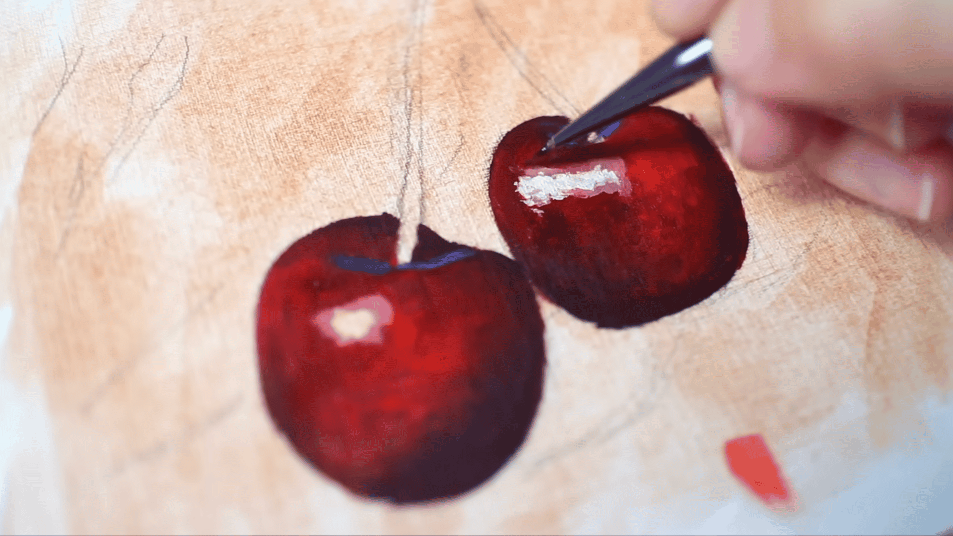 a liner brush placing thick titanium white highlight paint onto the surface of two red cherries in an oil painting