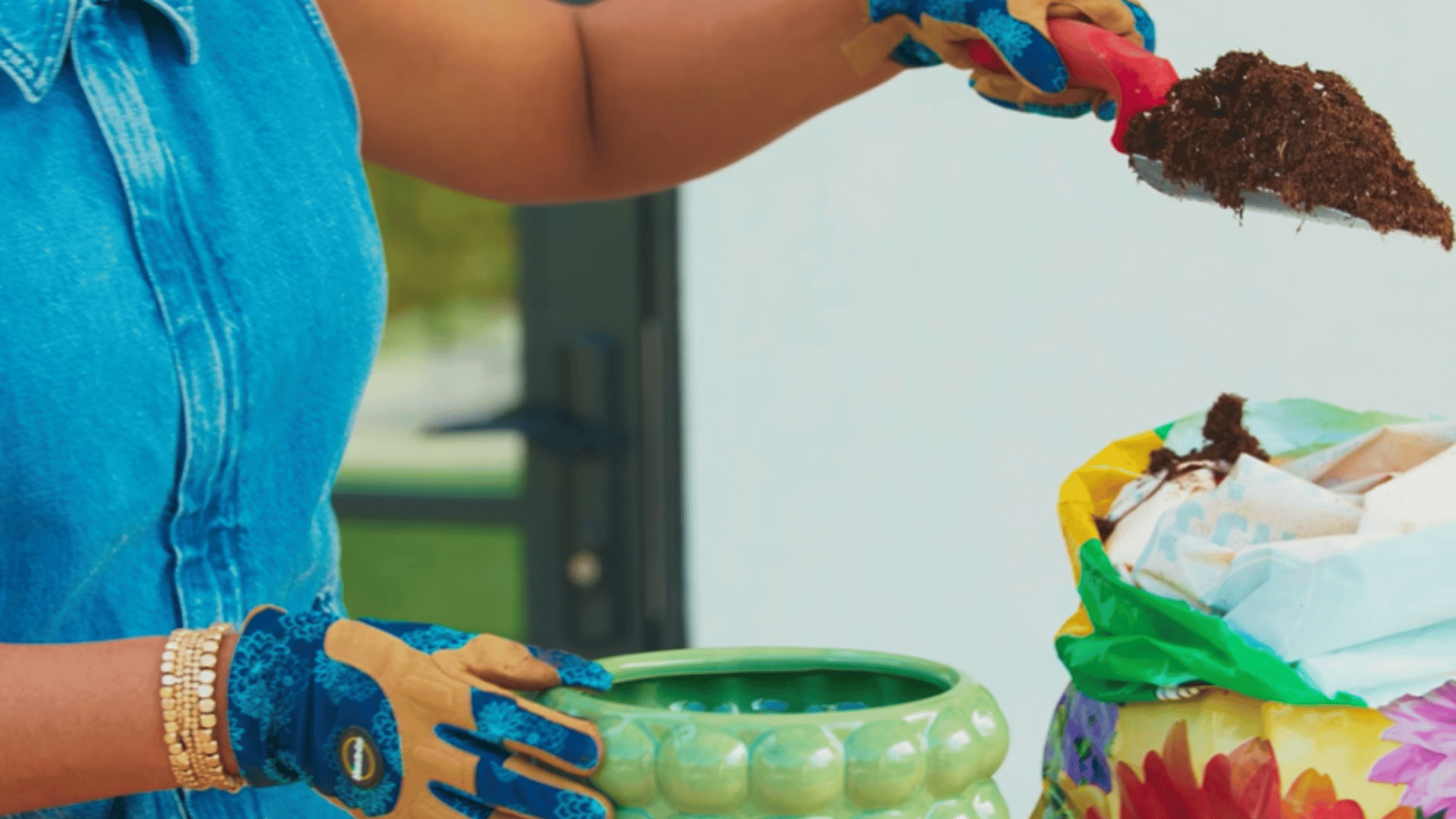 adding fresh potting soil to the new pot to prepare it before placing the plant