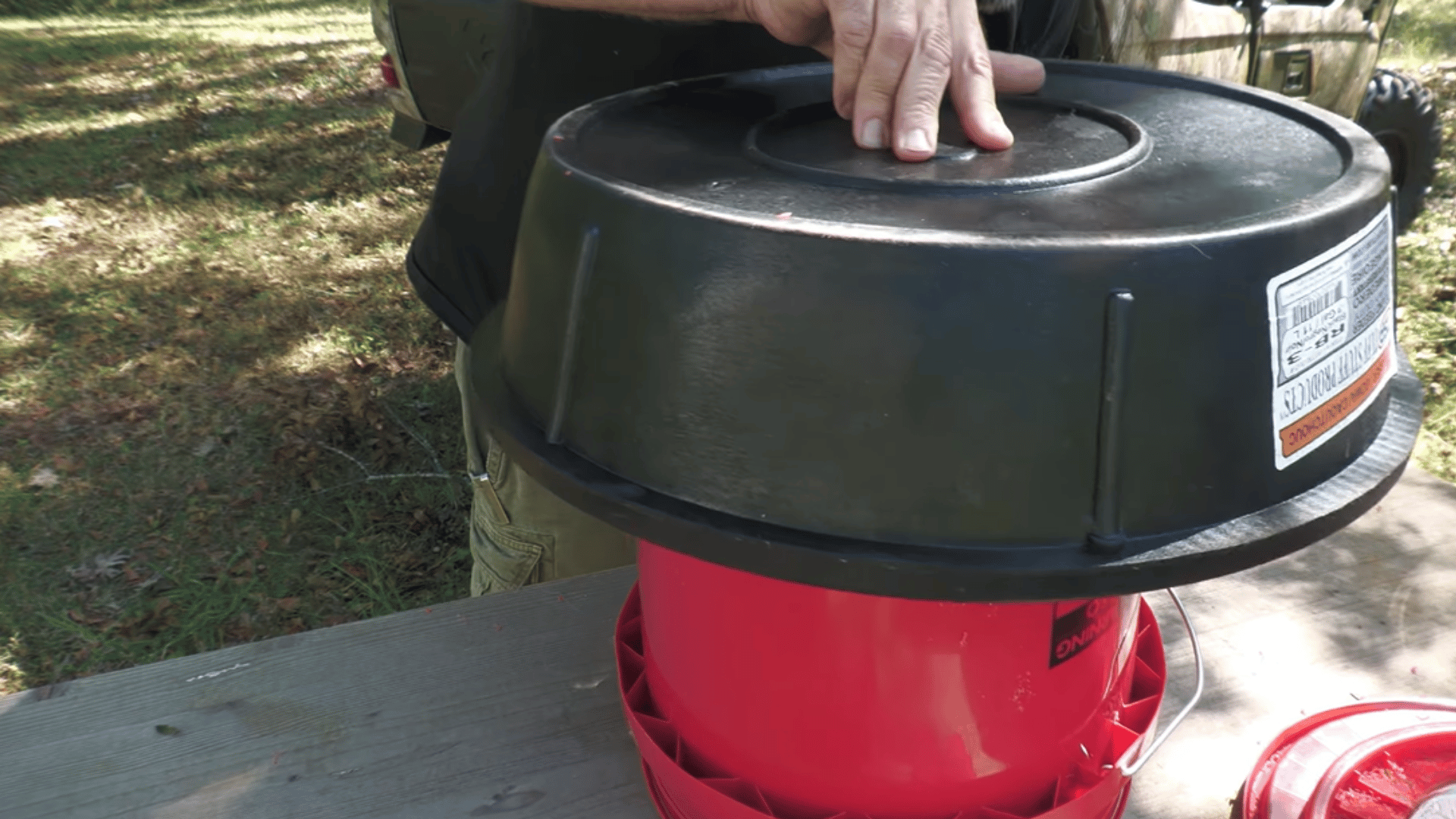 attach the bucket securely to a feeding tray with upside down bucket