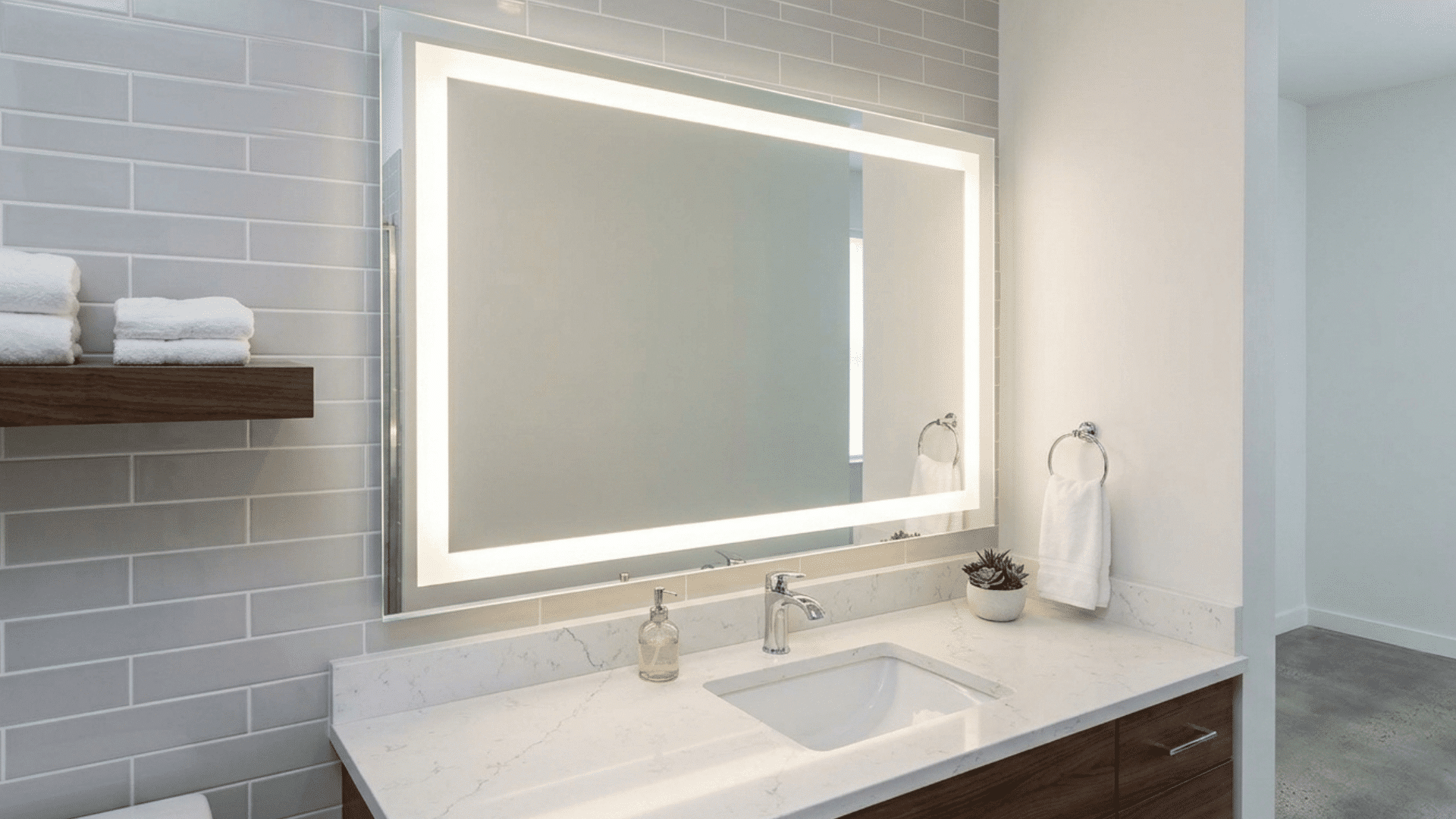 bathroom mirror with frame lighting creating soft and even glow.