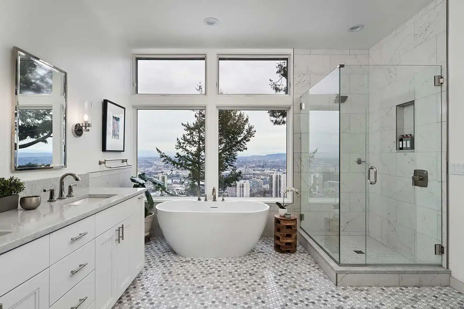 Spacious modern bathroom with freestanding tub and large windows overlooking cityscape