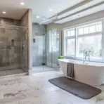 Luxurious bathroom with freestanding bathtub, large glass shower, and natural light from big windows