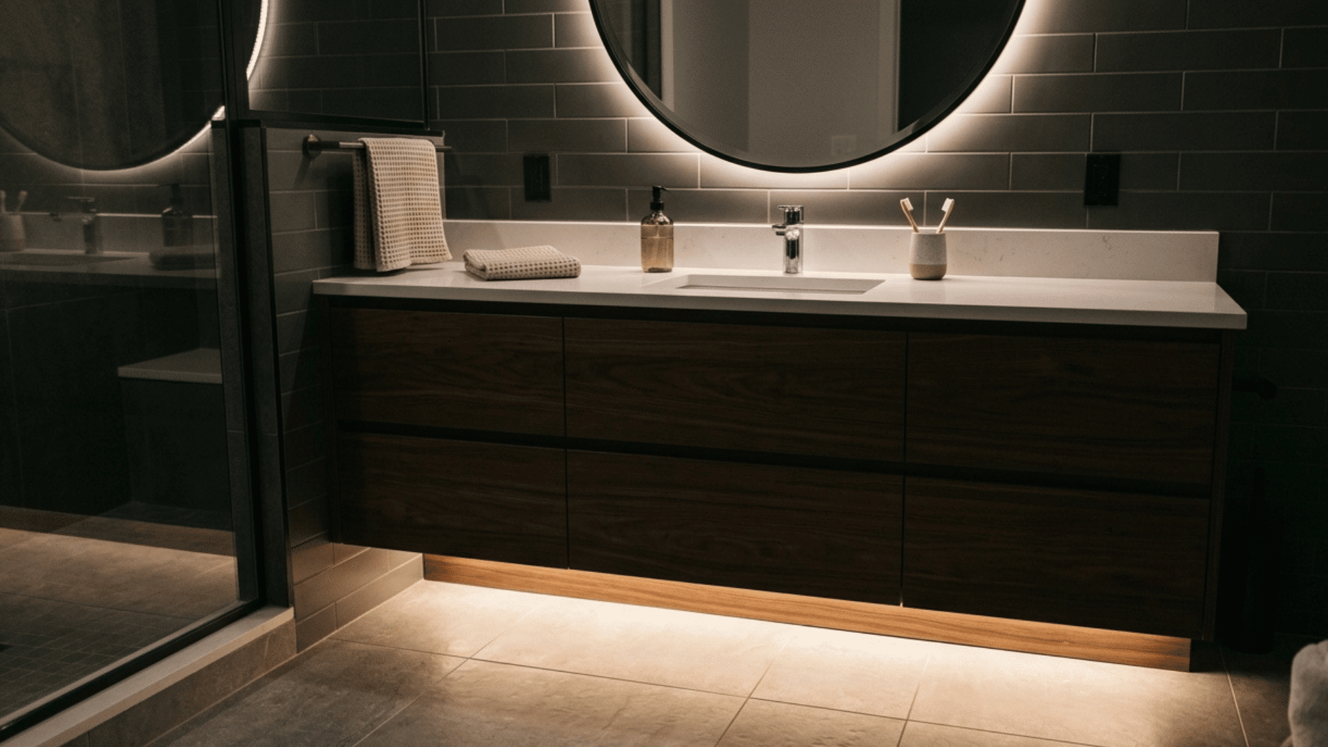bathroom vanity with toe-kick lighting creating a soft floor-level glow.