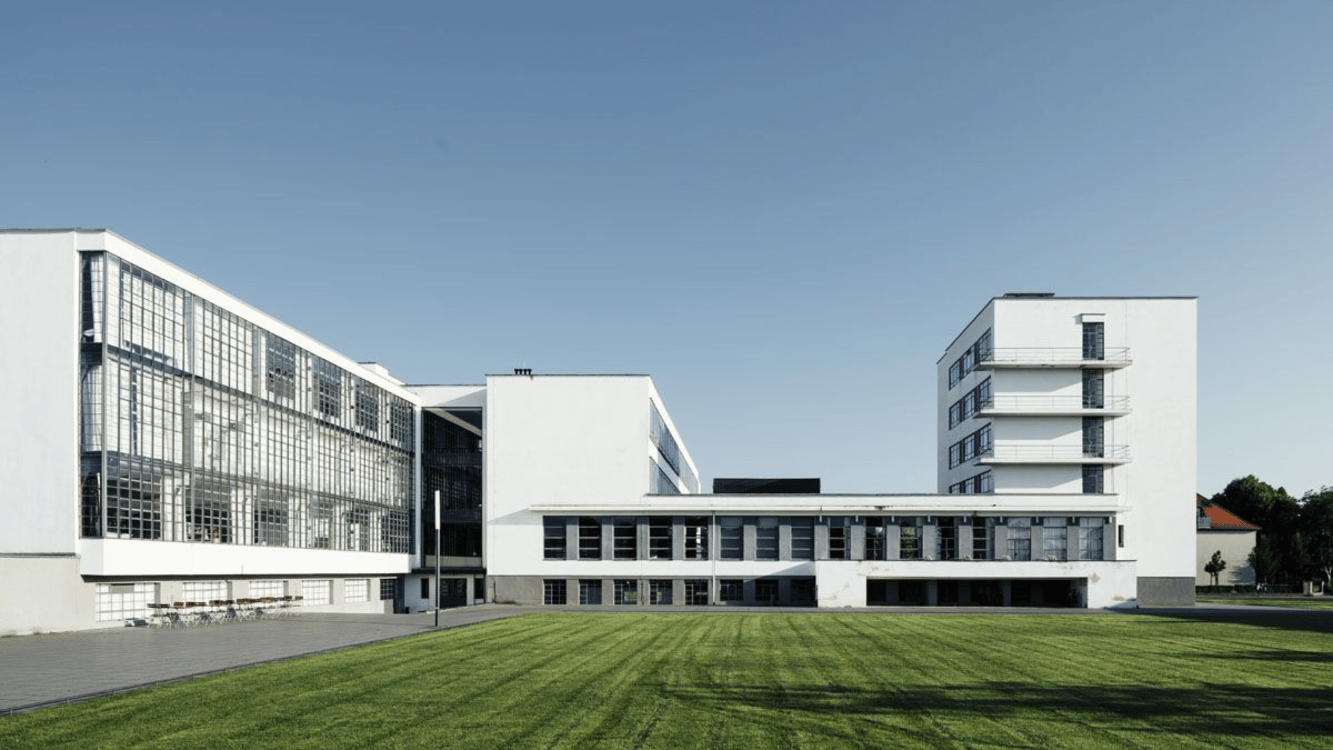 bauhaus building with clean lines, flat roofs, and glass façade, showing functional design in modern european architecture style. (1)