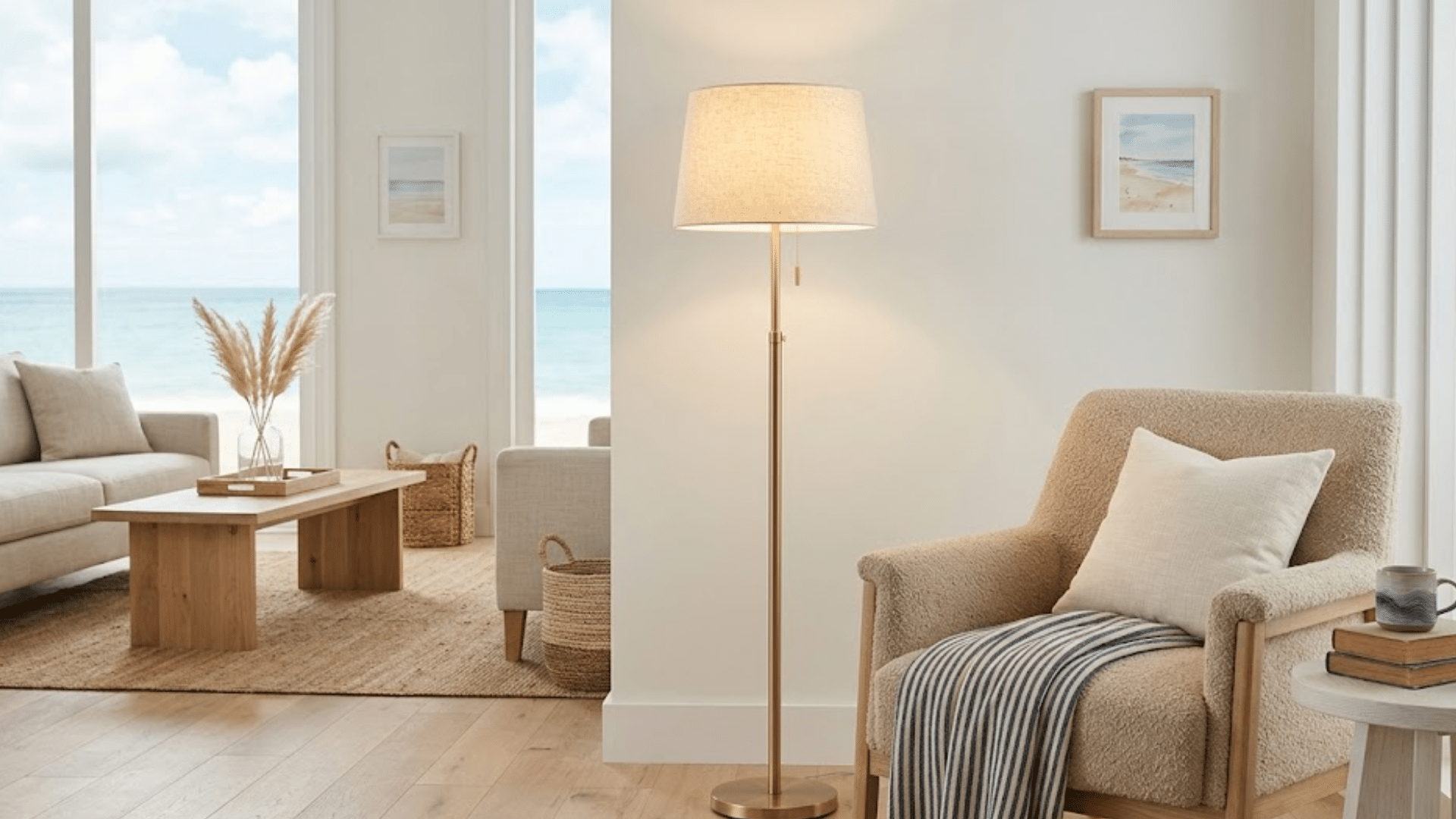 beach style living room with armchair floor lamp wooden table ocean view and light neutral decor throughout