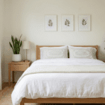 bedroom with white bed and three indoor plants near bed in soft natural light clean minimal setup