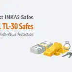 Stacks of cash, gold bars, diamond ring, and keys on light background