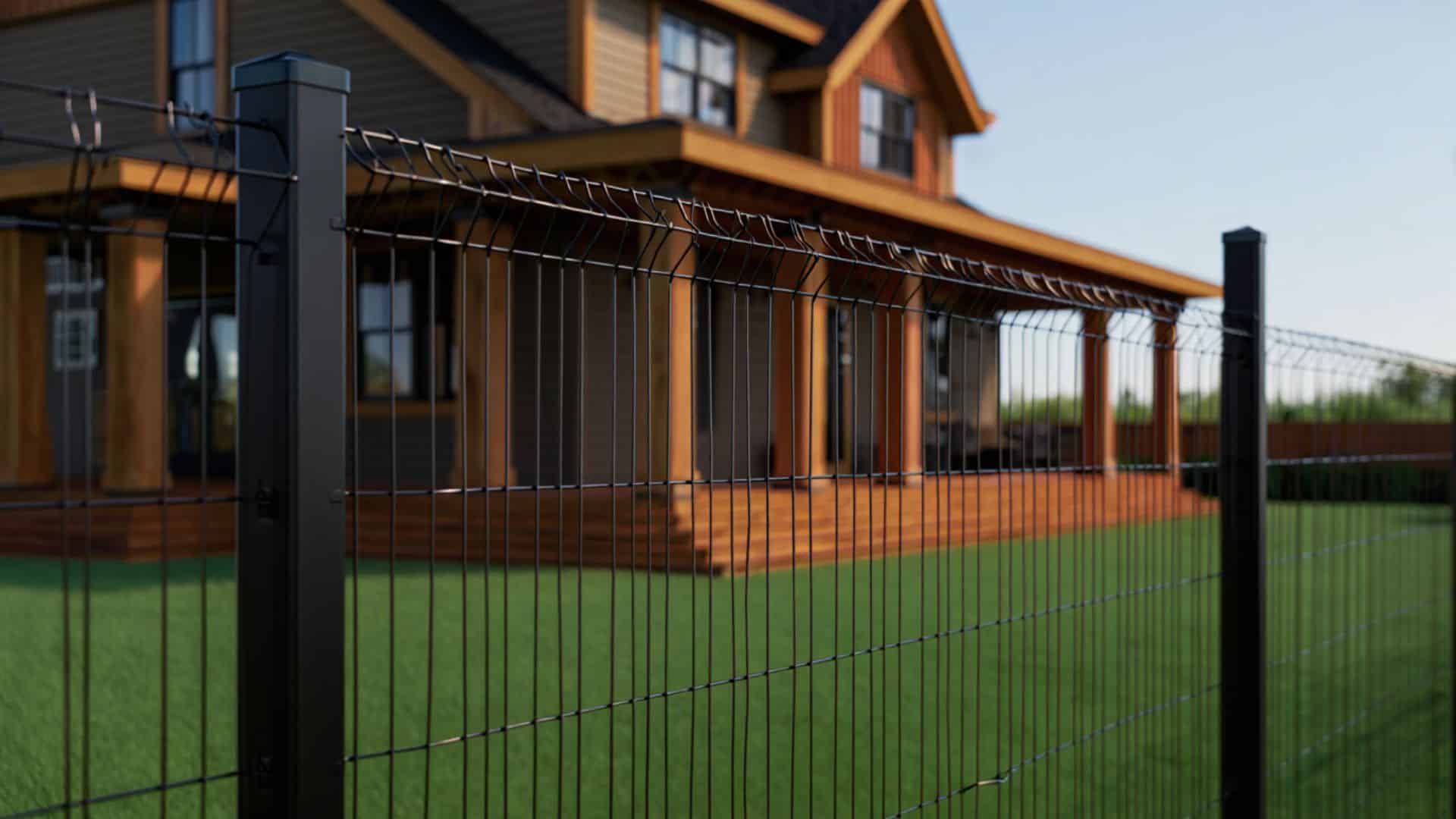 black powder-coated hog wire fence with metal posts installed around a modern home and landscaped backyard lawn