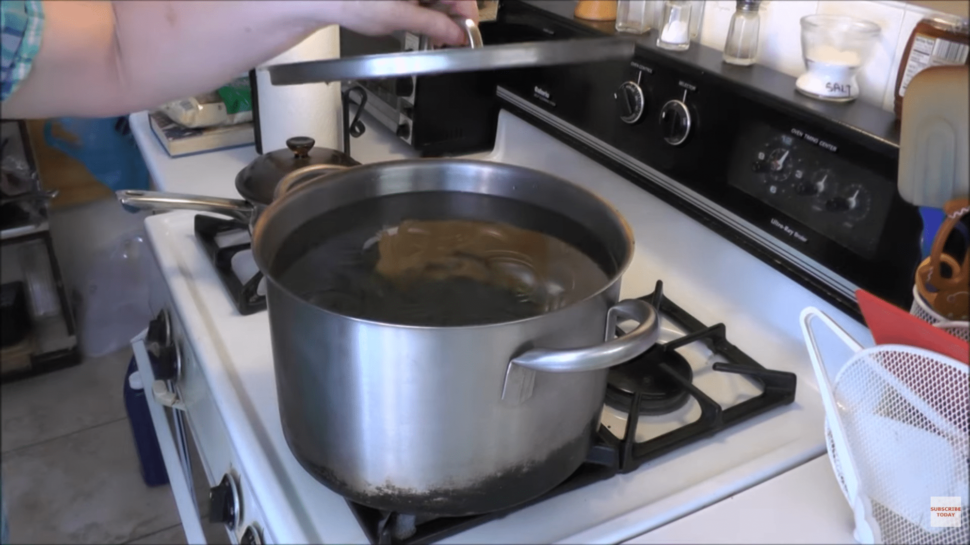 boiling jars in pot and simmering lids in water for sterilization