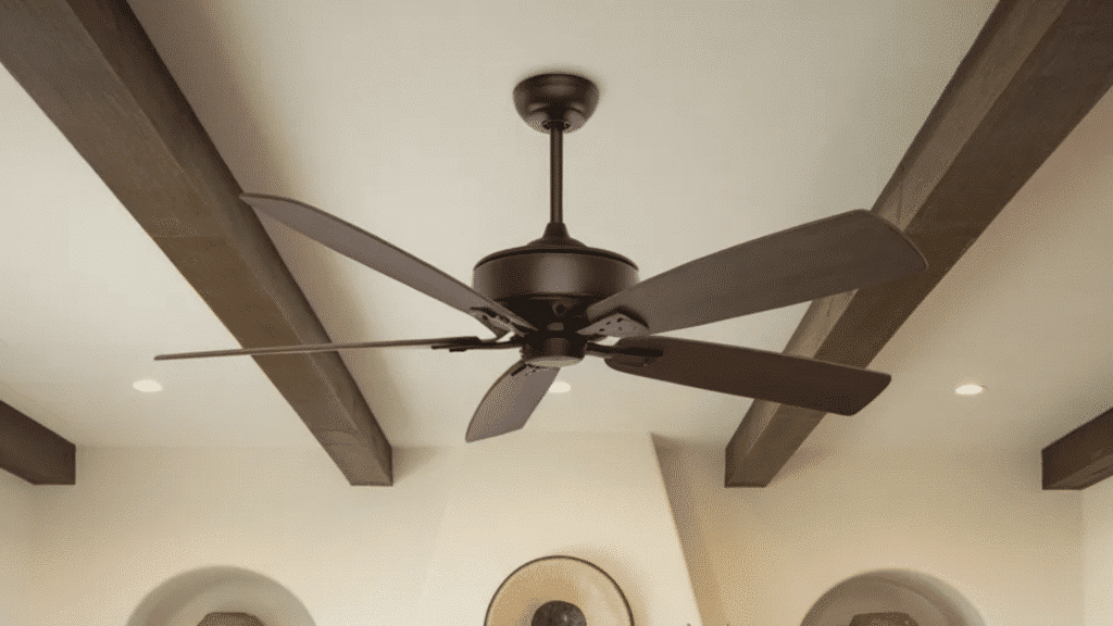 ceiling fan with dark wood blades mounted between exposed wood beams in bright living room