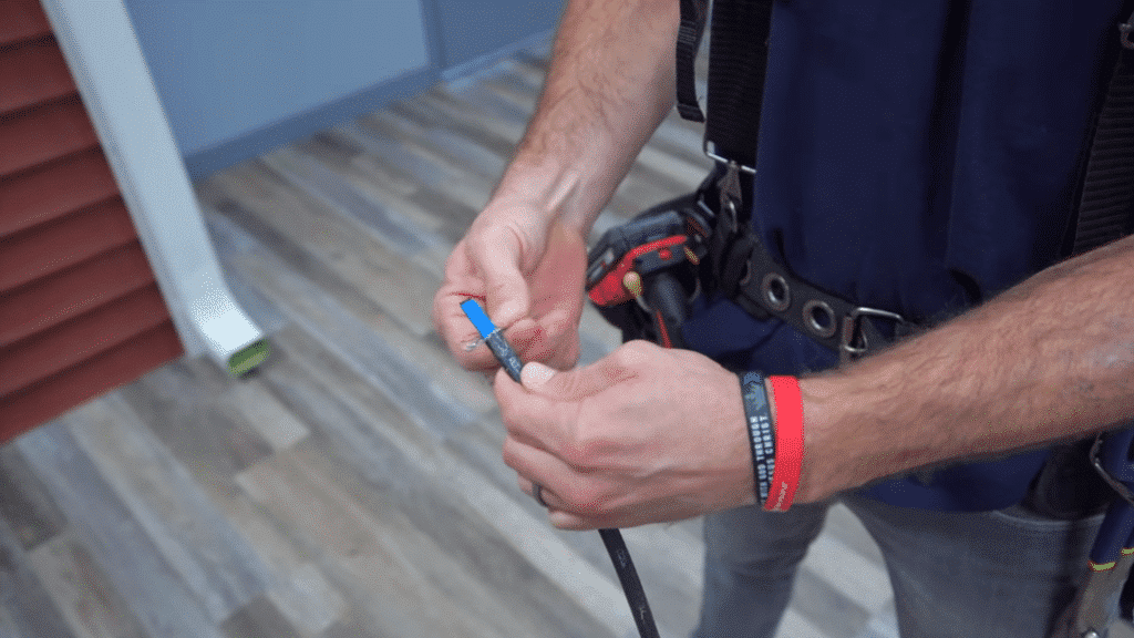 close-up of preparing and stripping heat cable for installation.