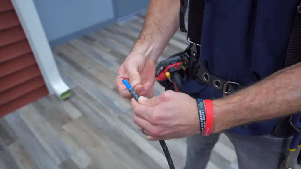 close-up of preparing and stripping heat cable for installation.