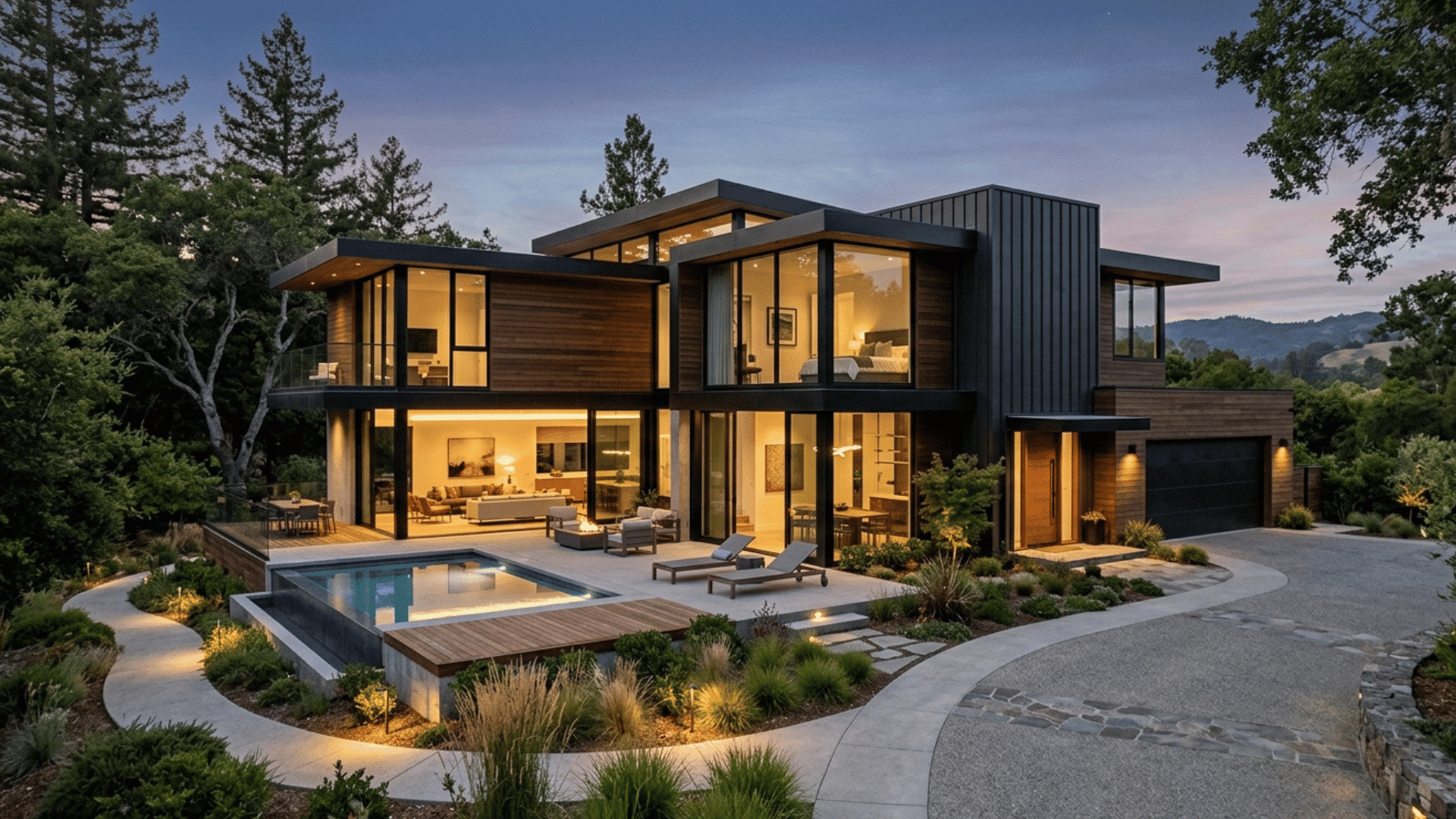 contemporary house exterior at night with glass walls and pool area.