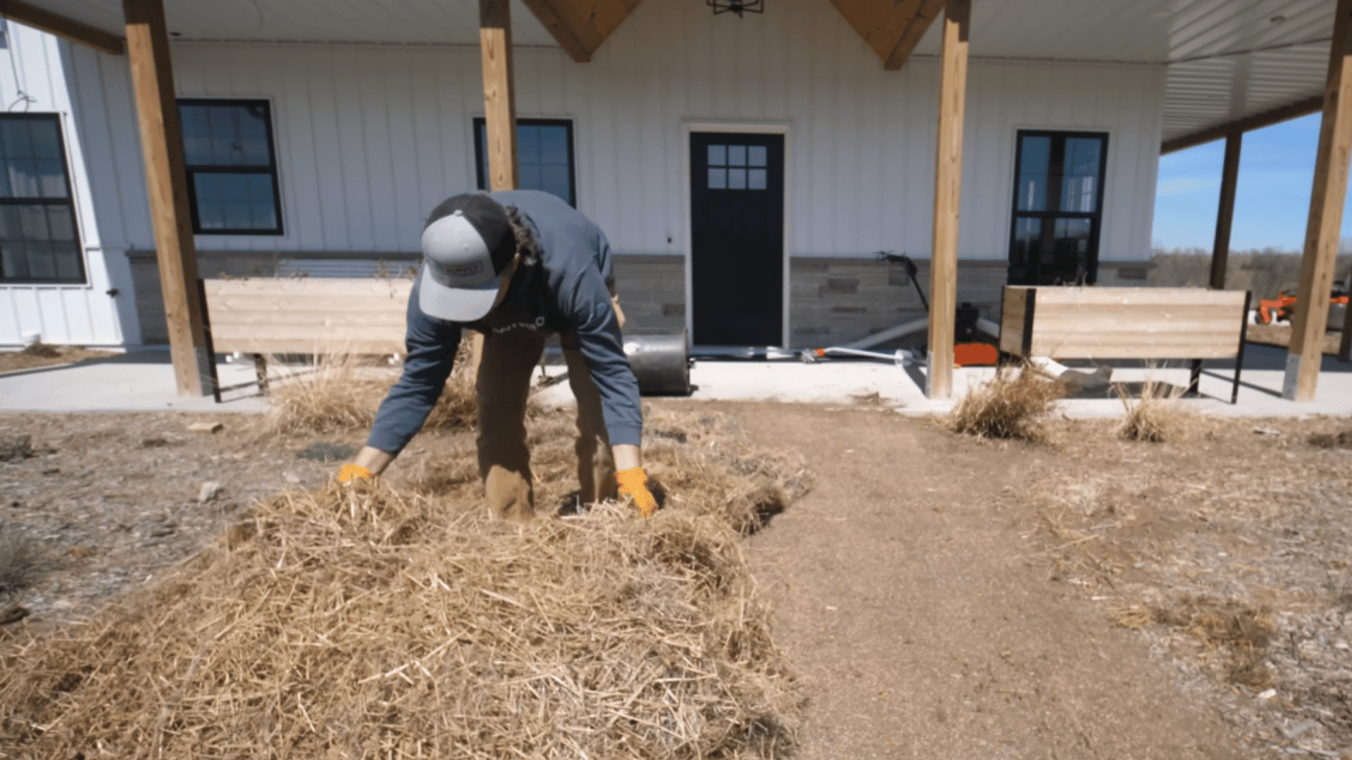 covering grass seed area with straw blanket to protect and retain moisture