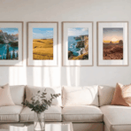 cozy living room with a light-colored sofa cushions a glass coffee table with a plant and four framed landscape photos arranged neatly on a white wall above the couch
