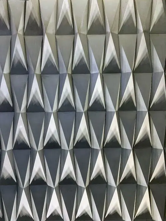 Geometric pattern with three-dimensional triangular shapes in shades of gray and white