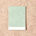 escape gray paint sample card placed on a wooden table, showing soft neutral color for home