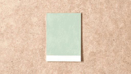 escape gray paint sample card placed on a wooden table, showing soft neutral color for home