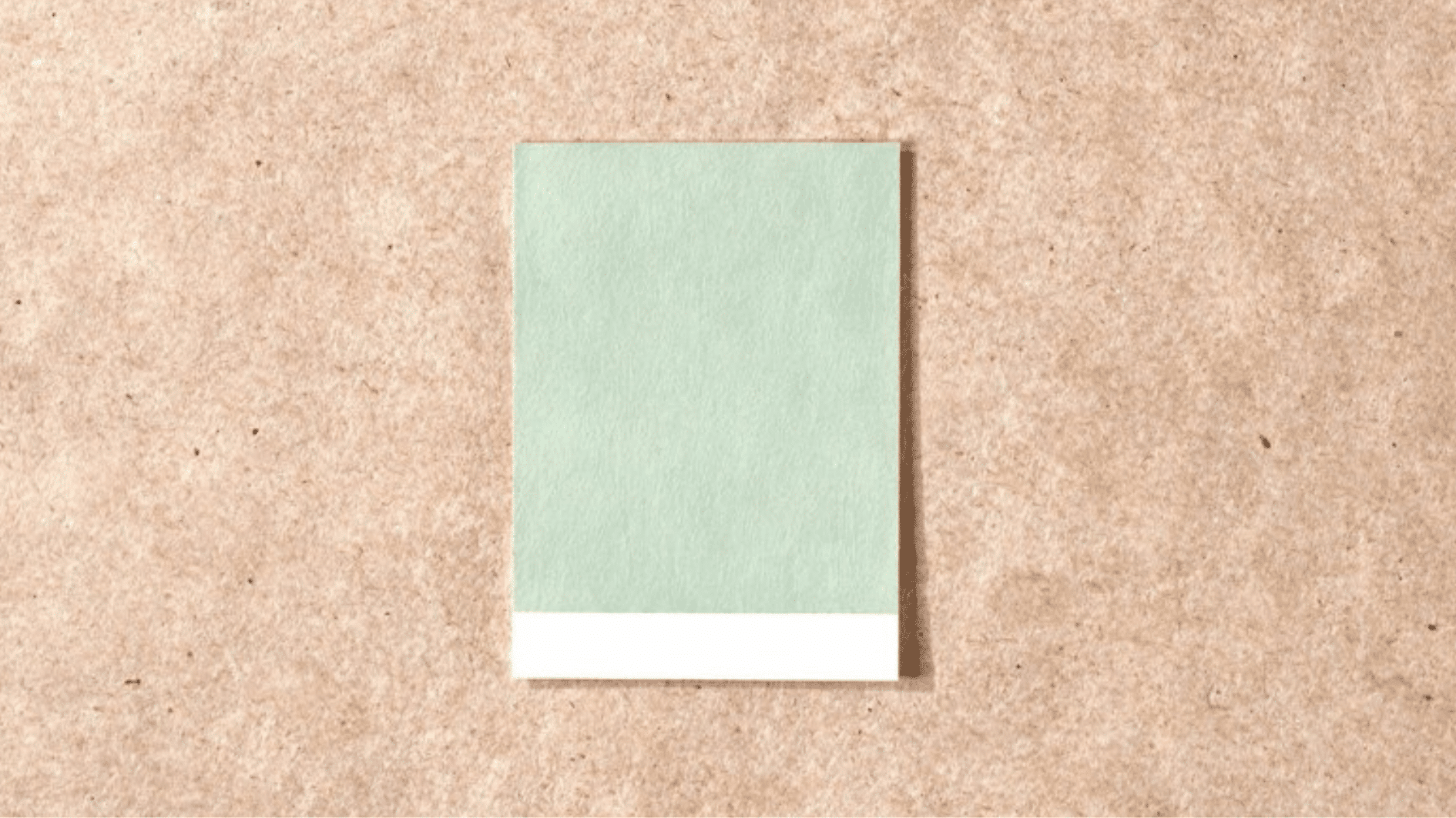 escape gray paint sample card placed on a wooden table, showing soft neutral color for home