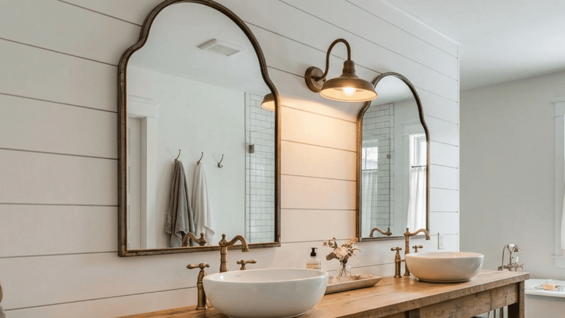 farmhouse bathroom with wood vanity, arched mirrors