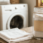 finished DIY reusable dryer sheets stored in a glass jar, ready for use with laundry for a fresh, clean scent.