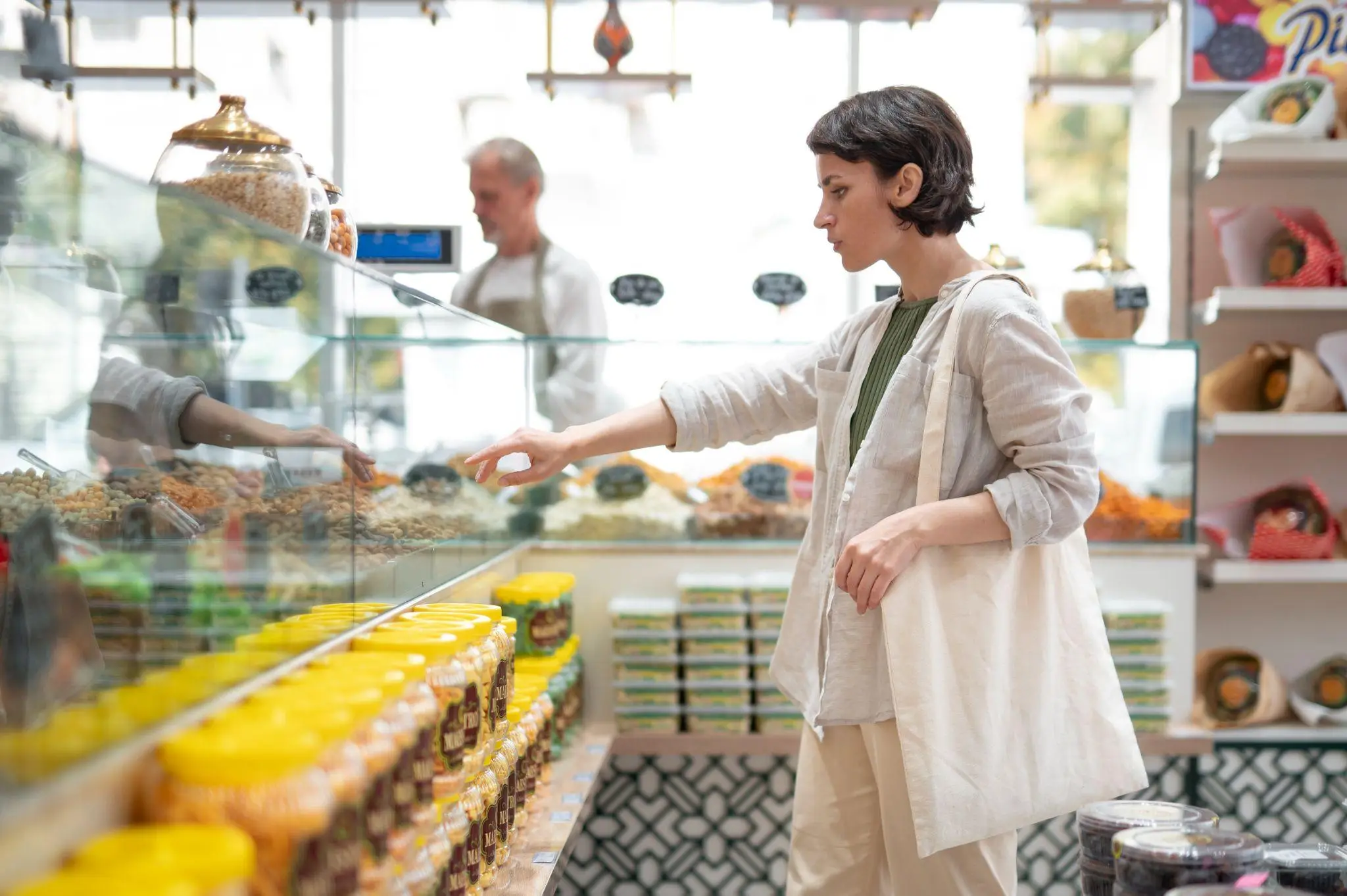 Shopper selecting items from glass display in a bright store setting