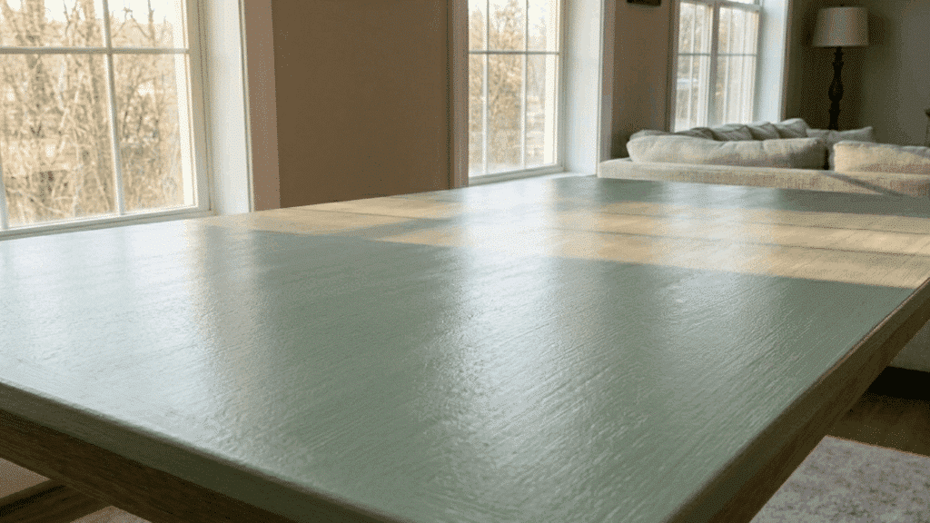 freshly painted wooden surface in green color left to dry in a clean indoor space with soft natural light coming in