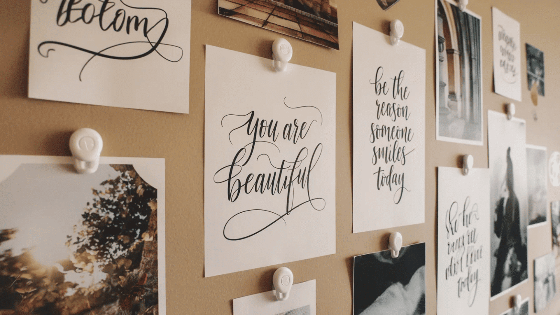 gallery wall with framed quotes and photos in light wood frames featuring messages like dream big and you are beautiful arranged neatly