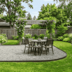 gravel patio ideas with defined metal edging and green lawn in a clean backyard space