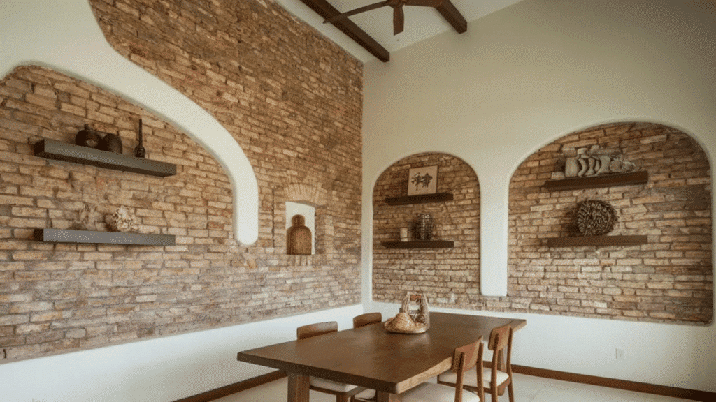 image shows a beautifully designed dining area featuring exposed brick walls with arched niches and floating wooden shelves.