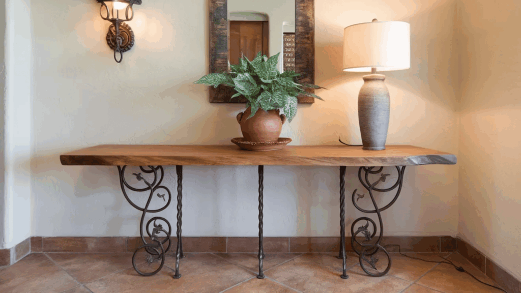 image shows a rustic table with decorative ironwork legs, featuring a potted plant and a lamp, providing a warm and welcoming vibe
