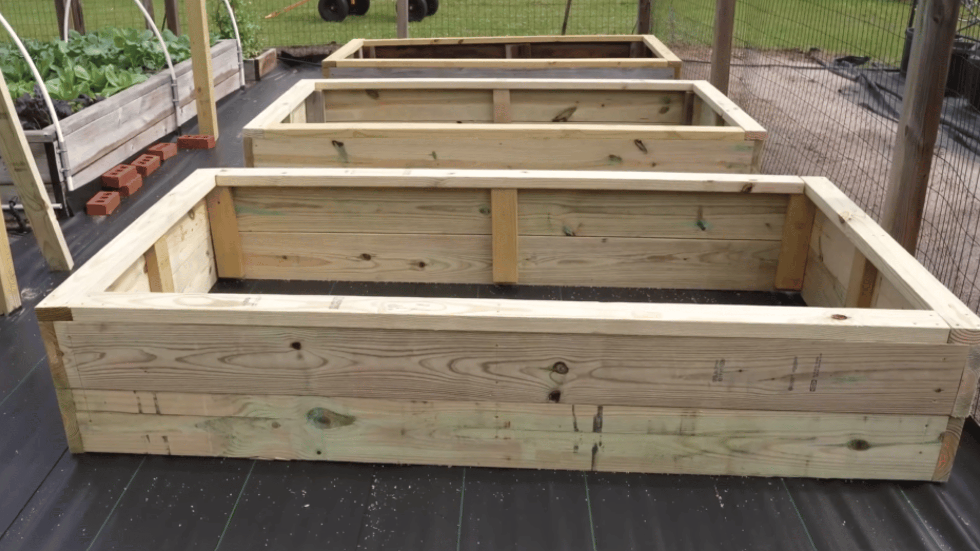 installed top railings on raised garden bed for seating support