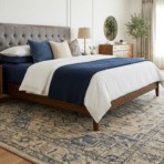 king bed with large area rug fully placed under bed and nightstands in a bright bedroom.