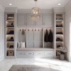 luxury modern mud room with built in bench, custom cabinets, open shelving, and soft neutral tones with natural light