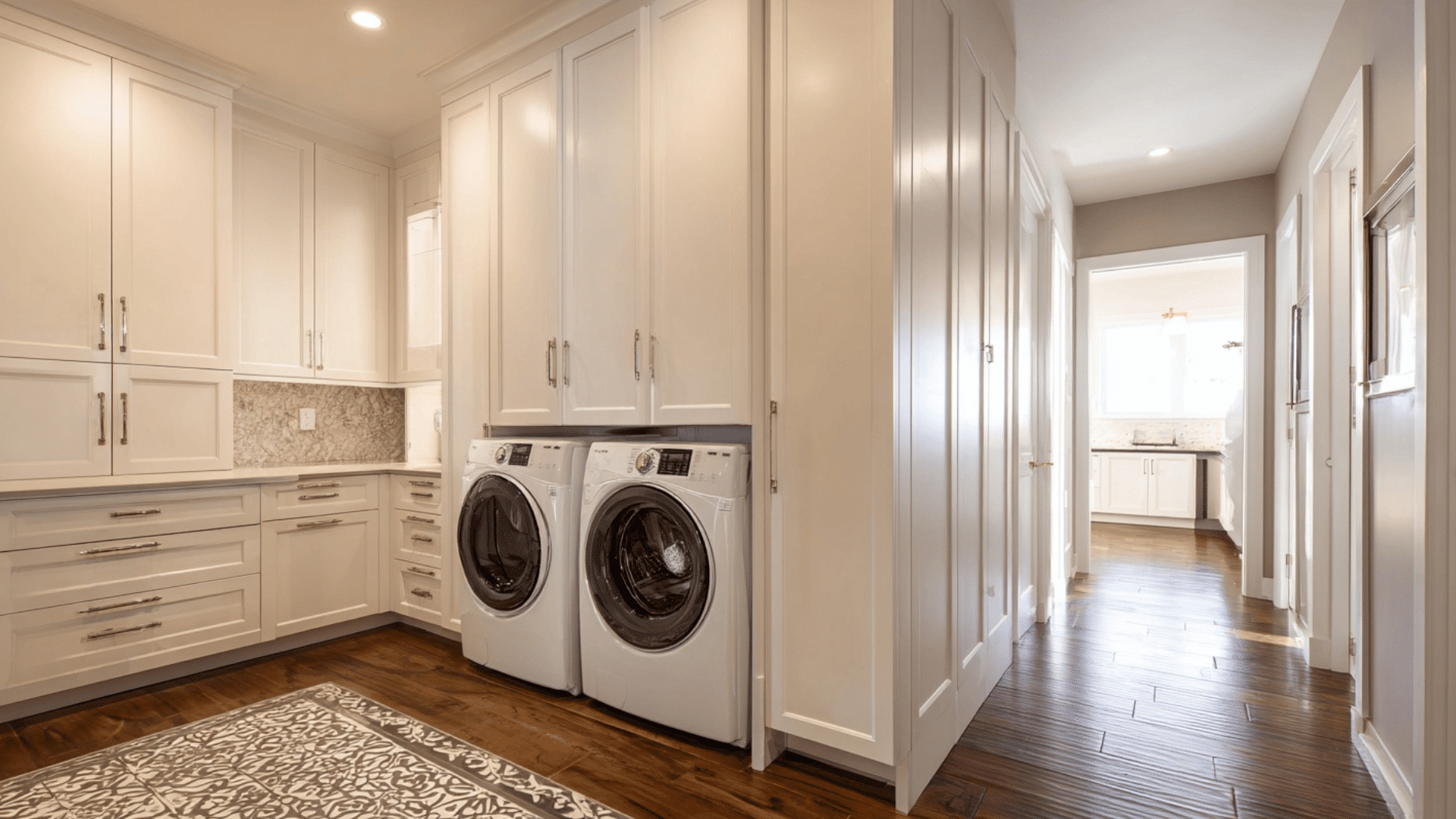 luxury mud room with hidden laundry setup and clean cabinets