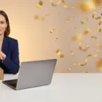 Woman in blue blazer with cardboard boxes and laptop in bright office setting