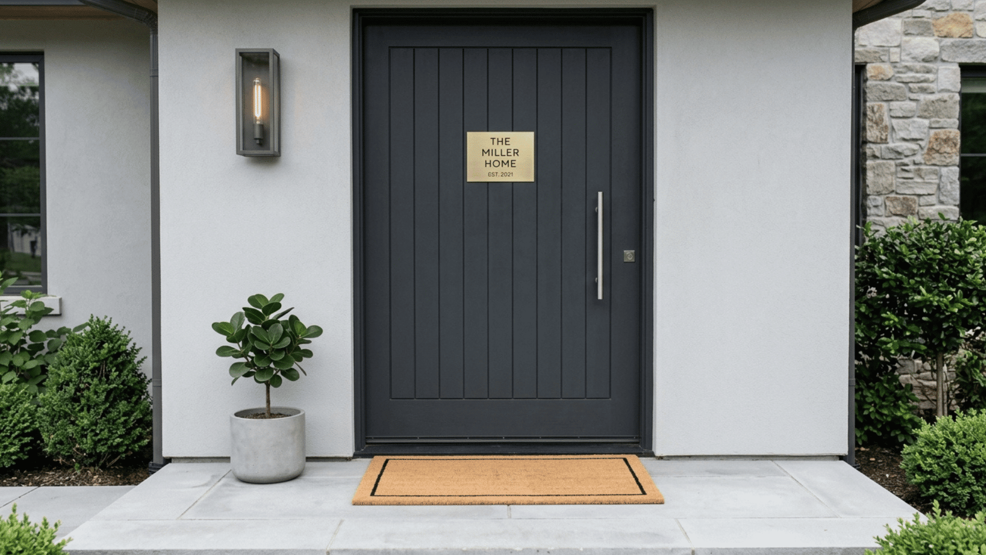 minimalist black front door with simple home sign and clean decor.
