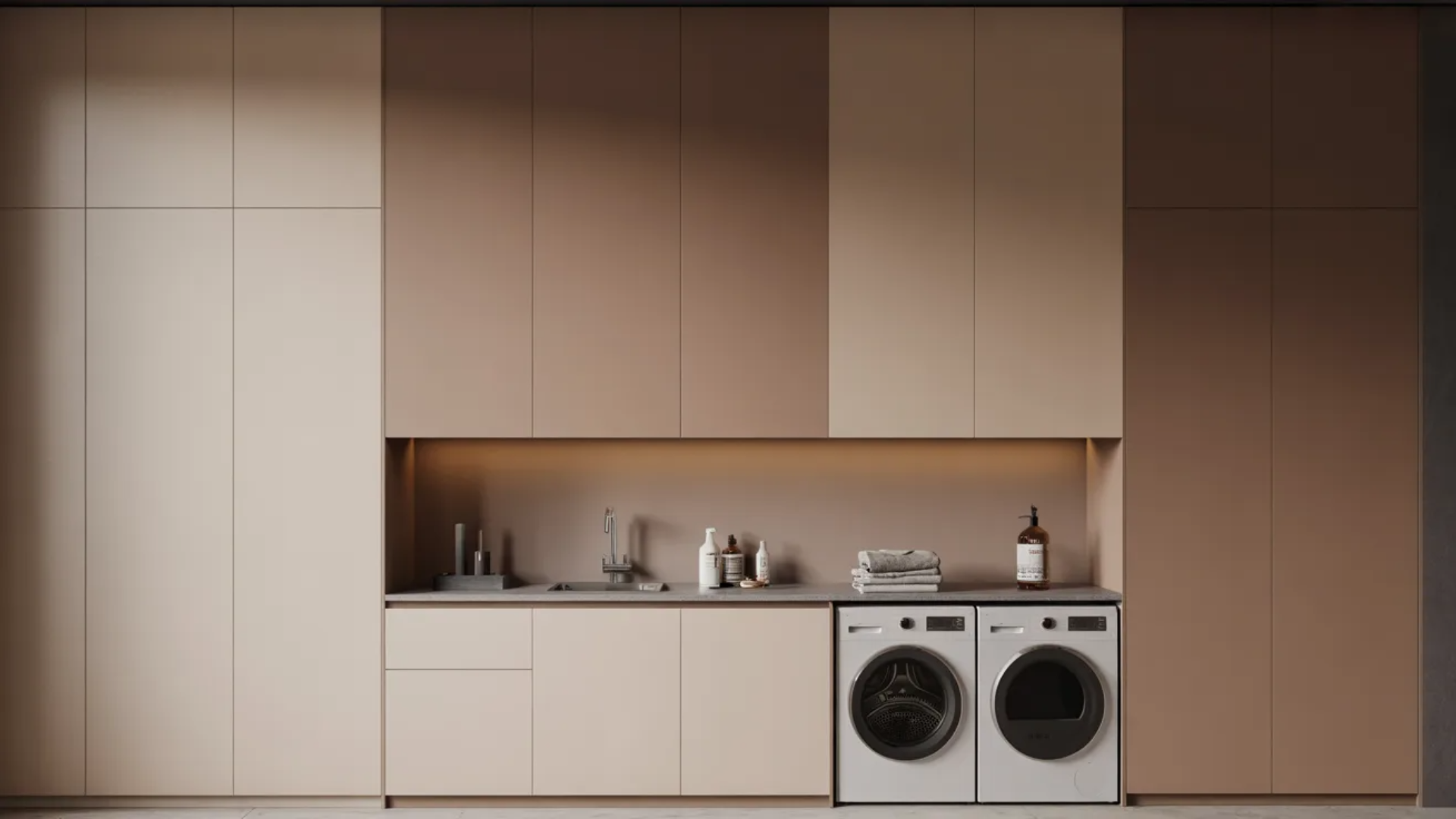 modern laundry room with neutral cabinets, washer and dryer, and clean countertop
