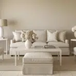 monochromatic beige living room with neutral sofa, armchairs, and decor creating a cohesive and elegant interior design