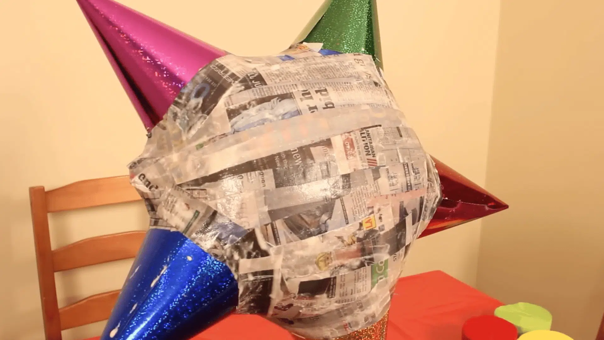 multiple layers of paper mache drying on balloon to create a strong and durable shell