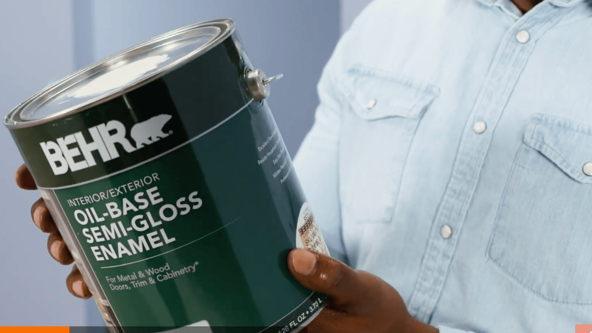 oil-based paint can being held to identify paint type before removing paint from carpet