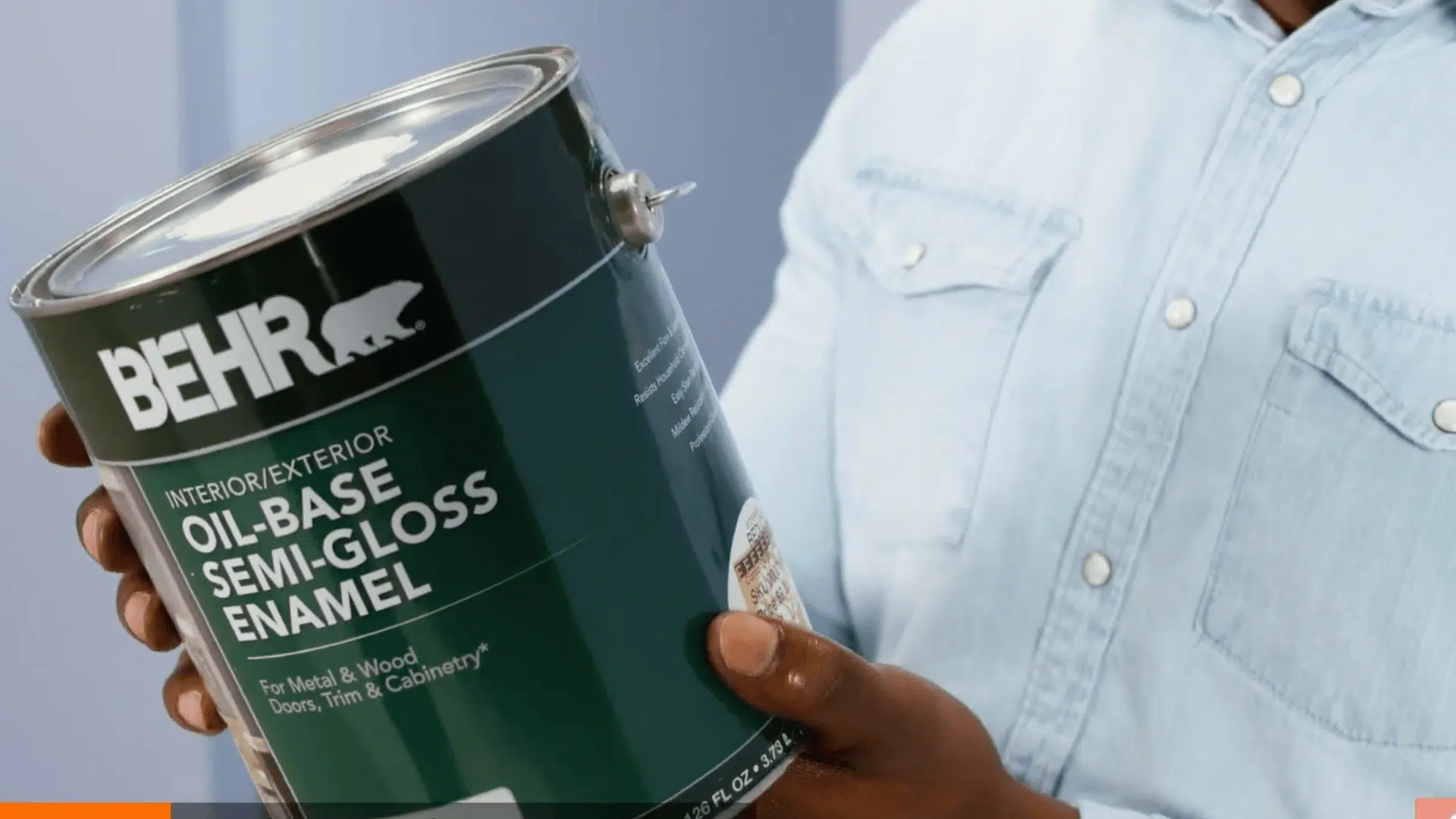 oil-based paint can being held to identify paint type before removing paint from carpet