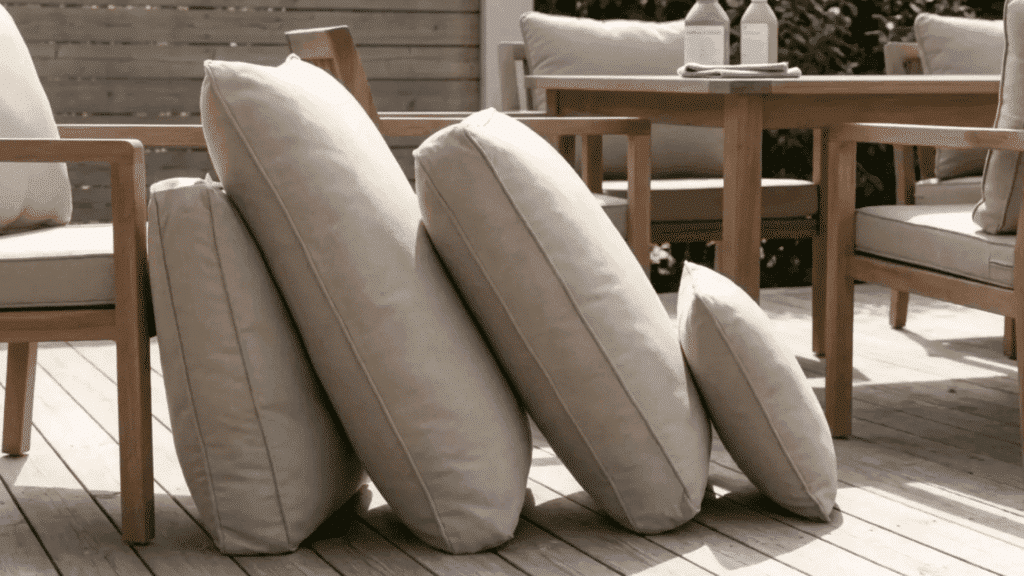 outdoor cushions standing upright on deck drying in sunlight after cleaning.