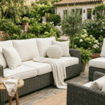 outdoor patio seating with clean beige cushions arranged on wicker furniture in a garden setting.
