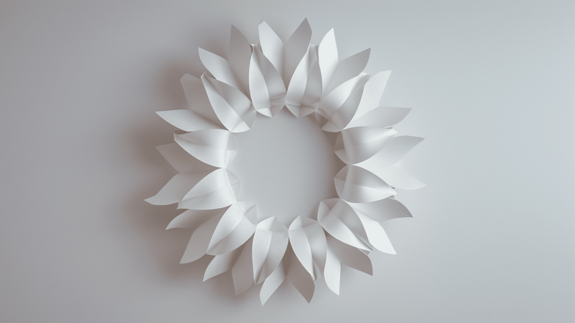paper wreath made with colorful shapes arranged in circular design hanging on wall with soft natural lighting (1)