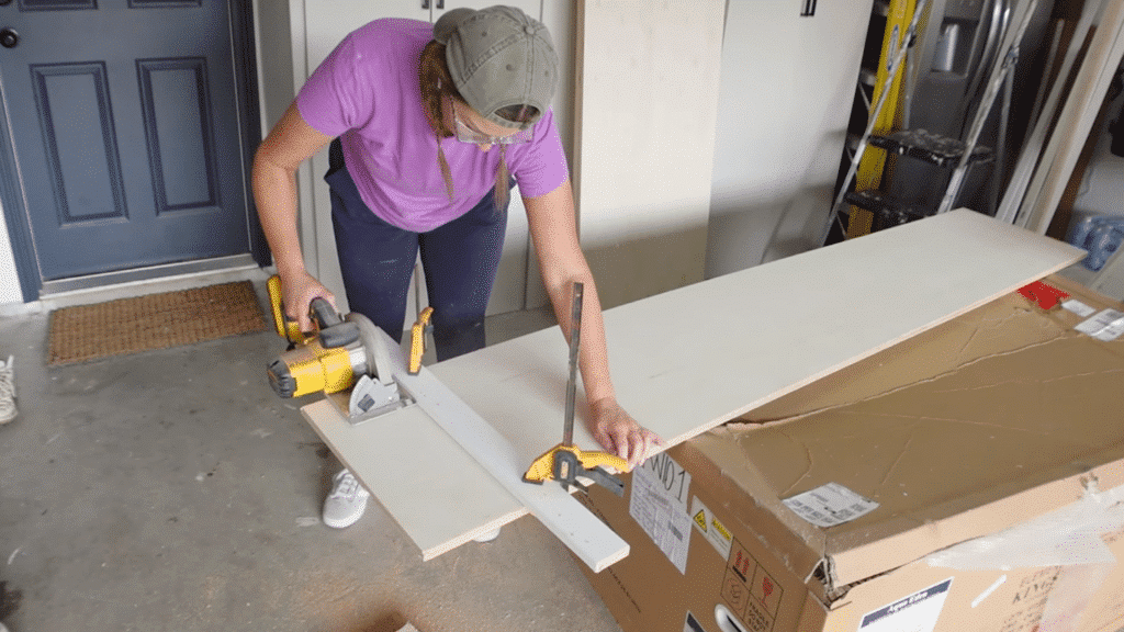 person cutting long wooden board with circular saw on workbench, securing plank with clamp for straight and precise cut
