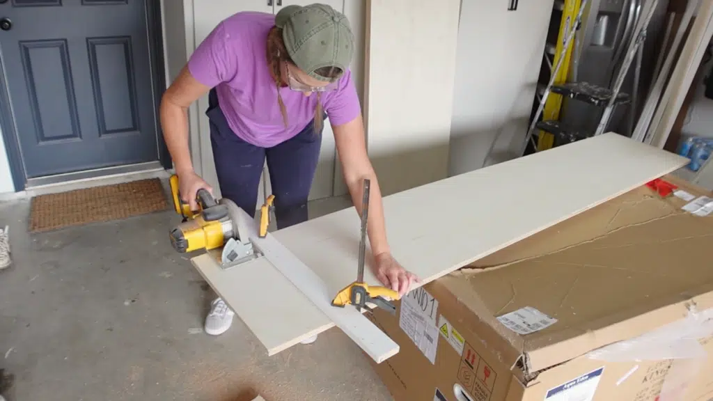 person cutting long wooden board with circular saw on workbench, securing plank with clamp for straight and precise cut